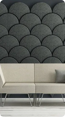 A modern interior featuring a textured gray wall with circular patterns
