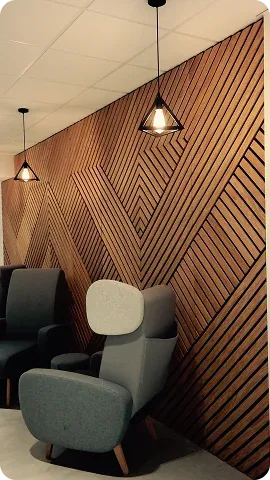 A modern lounge area featuring a geometric wooden wall design
