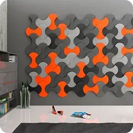 A modern wall covered with colorful, interlocking panels in orange, gray, and white